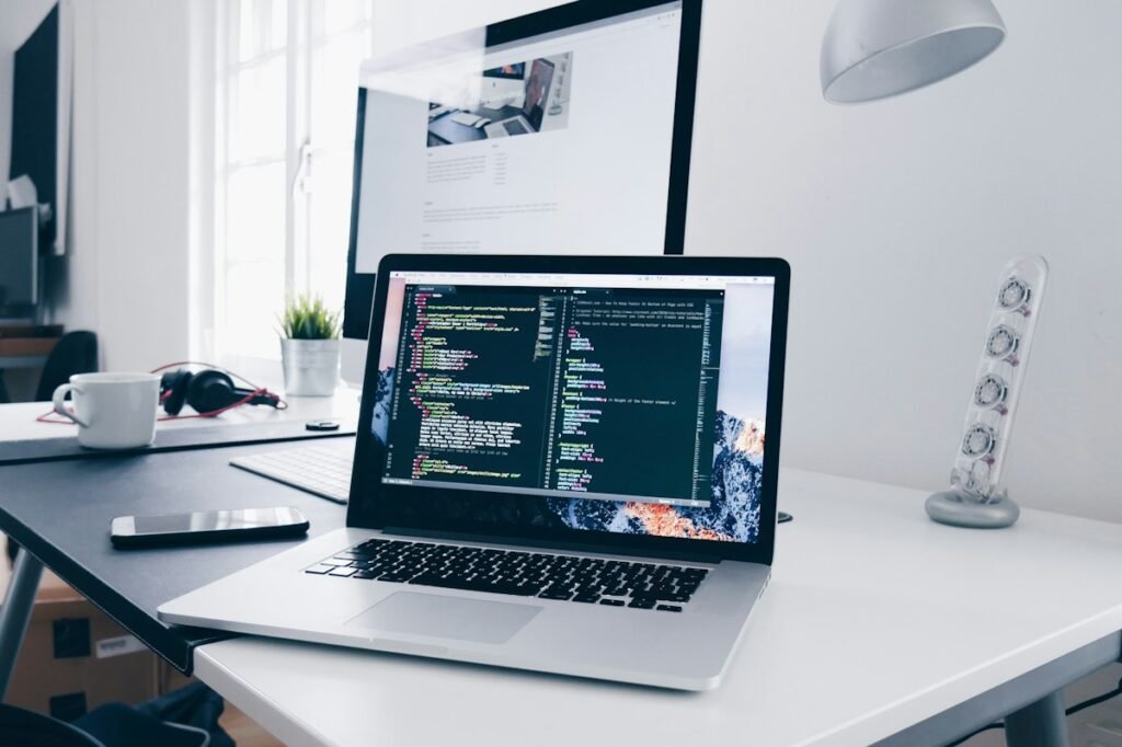 Laptop with website code on a clean work desk
